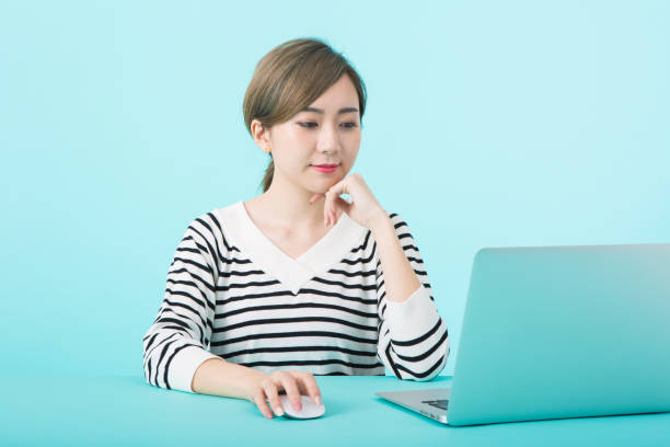 istock Young woman using laptop computer with happy face 1012259952