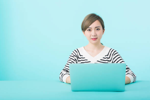istock Young woman using laptop computer with happy face 1012259956