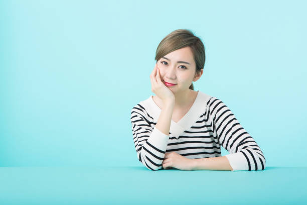 istock Young woman putting hand on cheek with happy face 1012260020