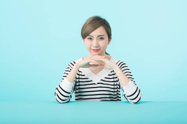 istock Young woman clasping hands with happy face 1012260092