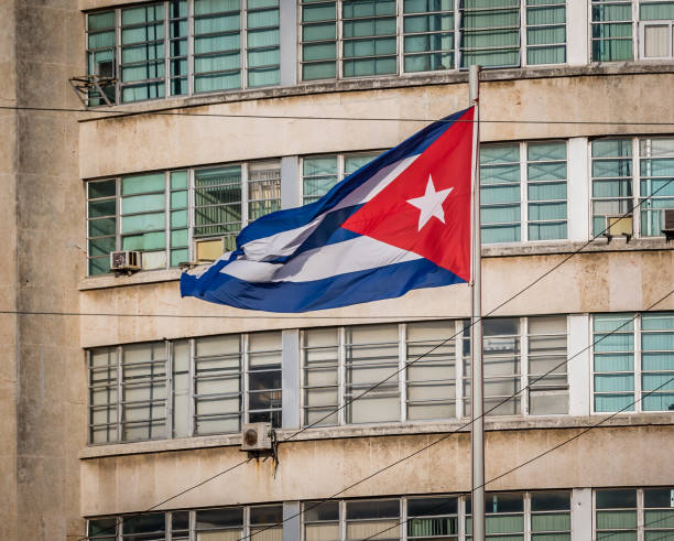 istock Cuban flag on a grunge decaying office building in 2015 1012271090