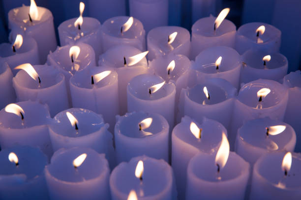 istock Many white candles burning. light for spirits, 1012287406