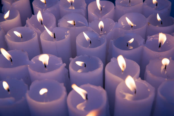 istock Many white candles burning. light for spirits, 1012289722