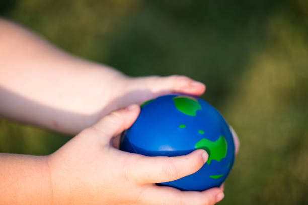 istock planet earth sphere being held by small toddler hands 1012294118