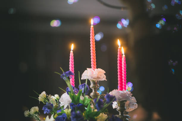 istock wedding candle on flower near wedding cake. 1012296590