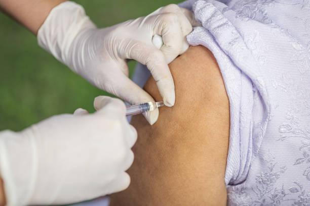 istock doctor giving a vaccine for a patient 1012303120