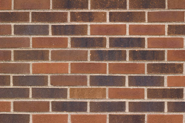 istock Traditional brown brick wall background with bricks of varying hues. 1012308750