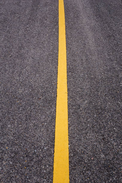 istock asphalt road with yellow line 1012308832