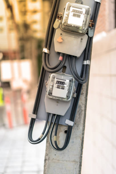 istock Electrical equipment. Electricity cable and crimper. Electricity meter on concrete pole along the street. 1012309006