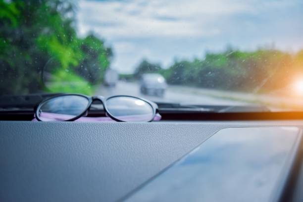 istock glasses and phone in car parked on road 1012312158