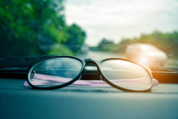 istock glasses and phone in car parked on road 1012312272