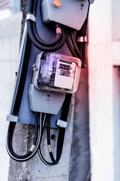 istock Electrical equipment. Electricity cable and crimper. Electricity meter on concrete pole along the street. 1012312470