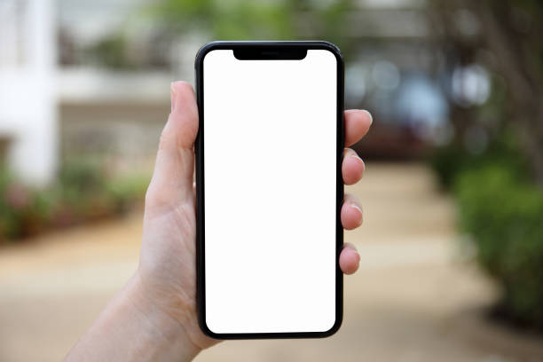 istock female hand holding phone with isolated screen on nature background 1012312736