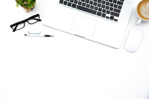 istock Top view with working desk with laptop,cellphone,notebook pencil coffee cup and eyeglasses in the office. 1012321090