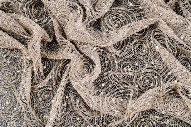 istock Texture, fabric, background. Lace fabric with a pattern of a circle, with a thread of gold thread 1012334876