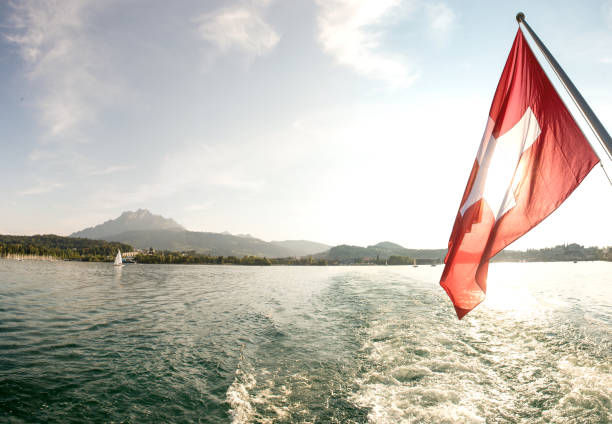 Leaving Lucerne at sunset with a sunset cruise on water switzerland Panorama stitched with 5 images. On the left you can see the Pilatus lucerne switzerland stock pictures, royalty-free photos & images