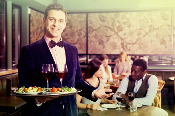 istock Polite waiter with serving tray 1012354530