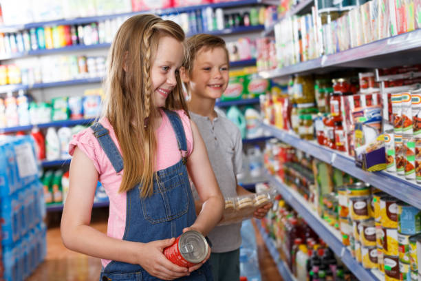 istock girl and boy choosing preserved meal 1012357108