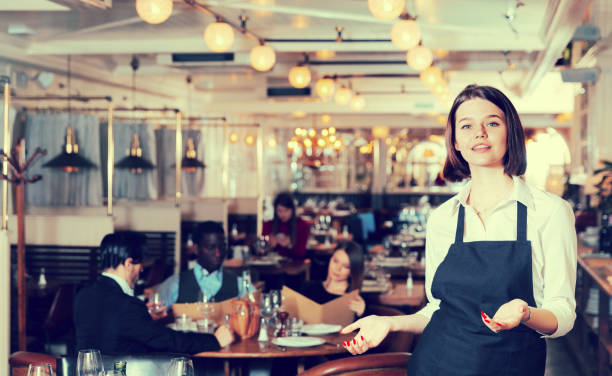istock Waitress meeting customers in restaurant 1012357378