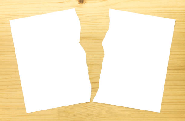 White Ripped Paper or Torn Paper in Half on Wood Background 2 White Ripped Paper in Half on Wood Background. White torn paper 2 part for separate or partition or divide concept half full stock pictures, royalty-free photos & images