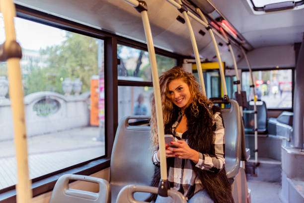 istock Woman with Smart Phone in the Bus 1012363630