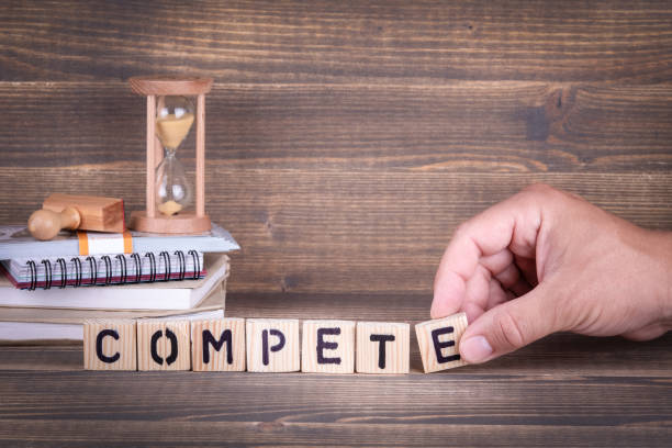 istock compete. wooden letters on the office desk 1012364594