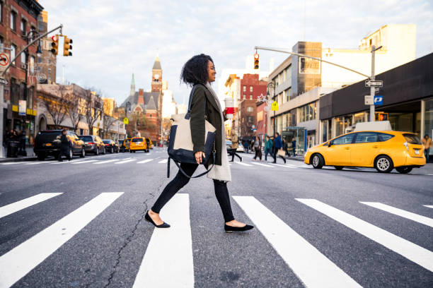 Successful and elegant woman walks the streets of New York Successful and elegant woman walks the streets of New York crosswalk stock pictures, royalty-free photos & images