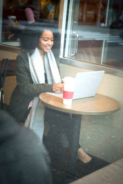 istock Young woman working on the move at cafe 1012366846