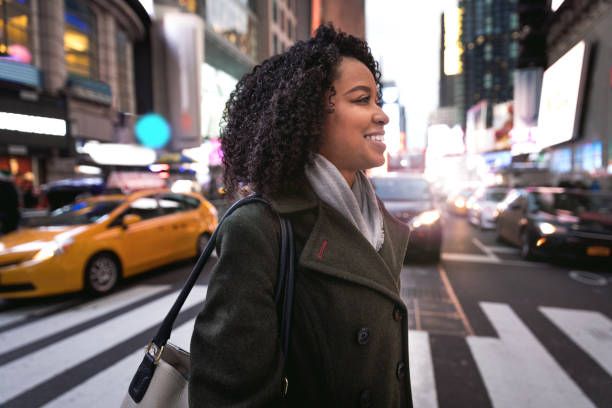 istock Successful and elegant woman walks in Times Square NYC 1012366894