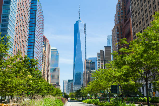 West Street and World Trade Center, New York The almost finished One World Trade Center in New York with blue sky seen from West Street one world trade center photos stock pictures, royalty-free photos & images