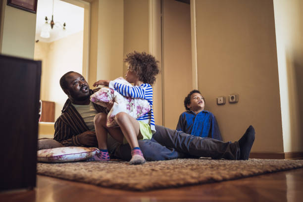 istock Kids having fun at home, playing with their father. 1012381108