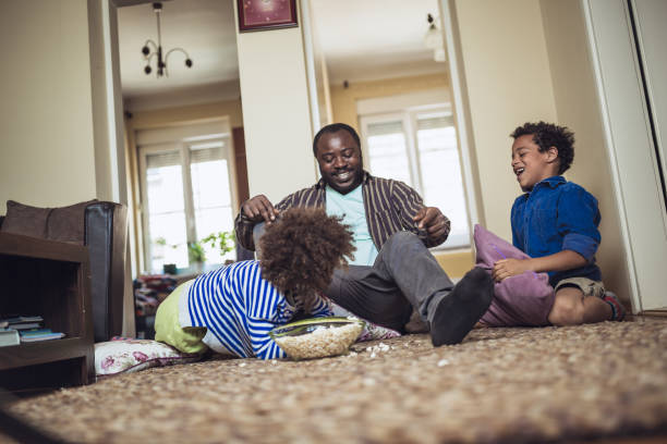 istock Kids having fun at home, playing with their father. 1012381128