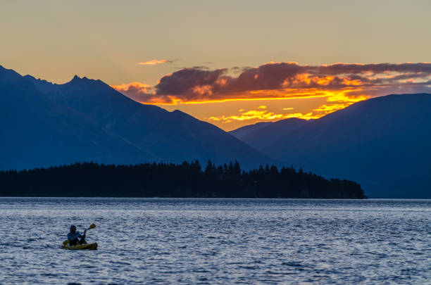 istock Sunset in Queenstown with Canoe floating on a lake 1012381168