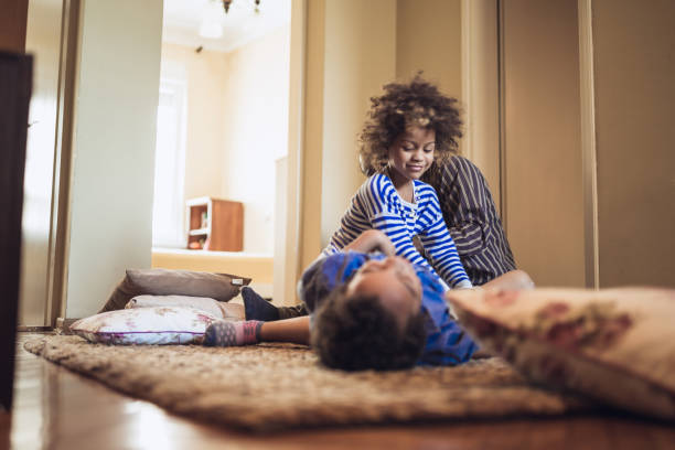 istock Kids having fun at home, playing with their father. 1012381184