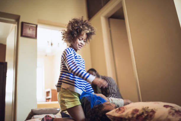 istock Kids having fun at home, playing with their father. 1012381192