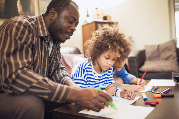 istock Kids having fun at home, playing with their father. 1012381302