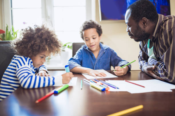 istock Kids having fun at home, playing with their father. 1012381344