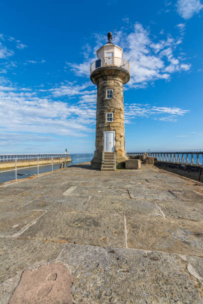 istock Whitby Lighthouse against blue sky - North Yorkshire, England 1012381744