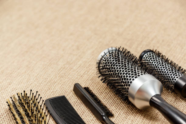 istock Combs and hairdresser tools on beige background 1012381768