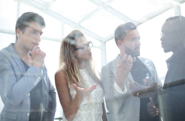 istock close up.business colleagues standing in the office 1012384332