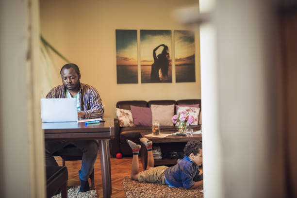 istock Young men working from home, while his children playing 1012384958