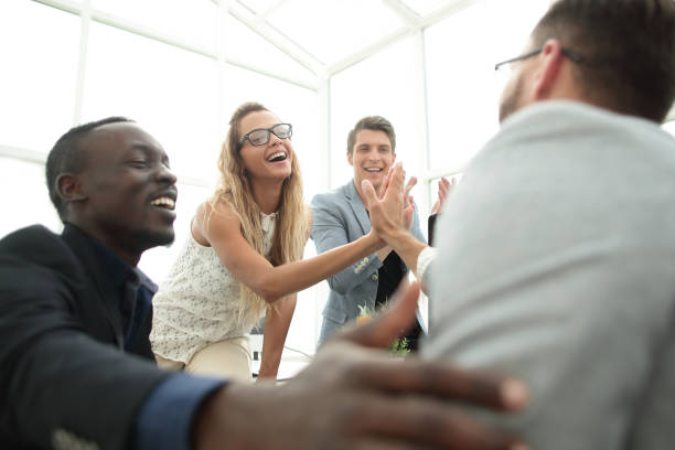 istock smiling employees giving each other a high five 1012385064