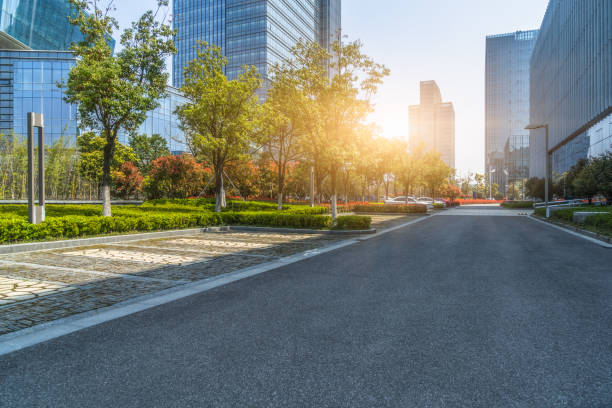 istock Modern glass building with empty asphalt road 1012389482