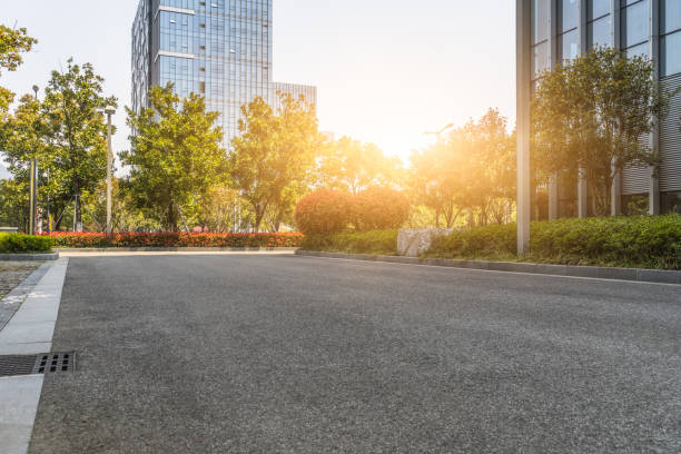 istock Modern glass building with empty asphalt road 1012389484