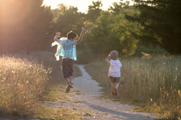 istock Happy children playing with plane 1012389660