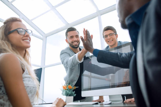 istock young employees giving each other high five 1012389772