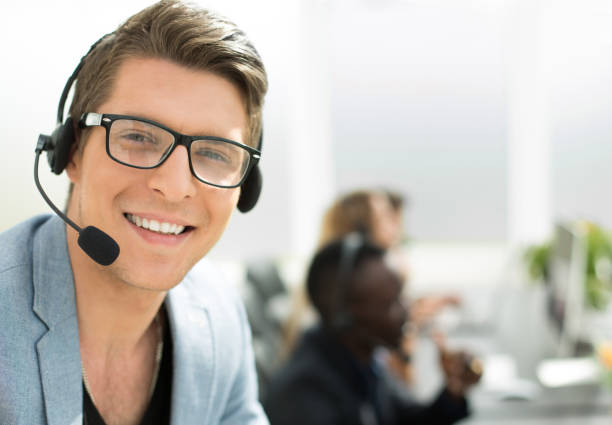 istock close up.call center operator on the background of the office 1012390326