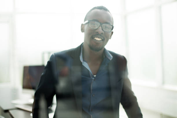 istock successful businessman looks through the office window 1012393182