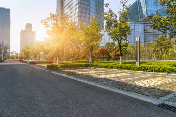 istock Modern glass building with empty asphalt road 1012393984