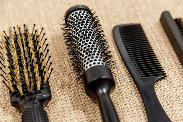 istock Combs and hairdresser tools on beige background 1012398048
